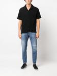distressed-effect mid-rise tapered jeans